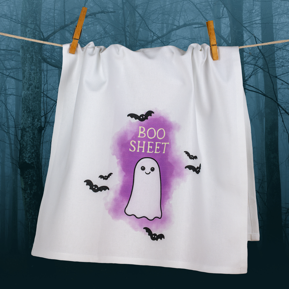 Boo Sheet dishtowel on a clothesline with a spooky misty background of bare trees.