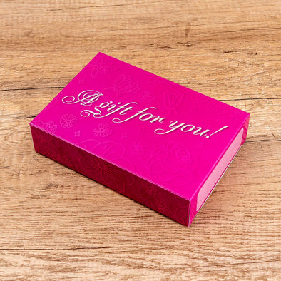 A built "A gift for you!" gift box. The box is pink with metallic flowers. Fits 2 towels