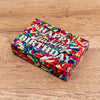 The "Happy Fucking Birthday" gift box that holds 2 towels. The background is a closeup of sparkles. The text is superimposed over the sprinkles on the top of the box.