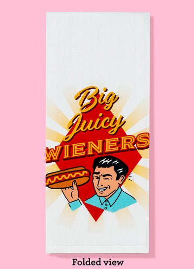 Folded towel with text Big Juicy Wieners and a 1950s man holding a hot dog and winking.