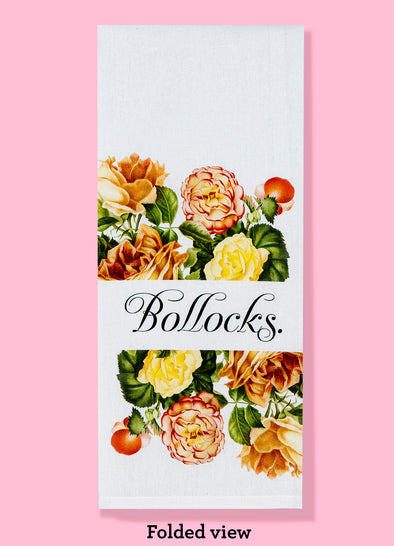 Folded dishtowel with the text BOLLOCKS featuring vintage yellow and orange floral illustration.