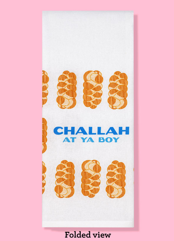 The folded view of Challah At Ya Boy dish towel. The towel features the text "Challah at ya boy" surrounded by illustrations of loaves of challah bread.