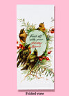 The "Fuck Off With Your Holiday Spirit" dishtowel, shown folded into thirds. It features the text as well as an illustration of a wreath with birds