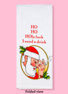 The folded view of the Ho Ho Holy Fuck dish towel. The text reads "HO HO HOly fuck I need a drink" with a side view of Satna Claus's face. He is holding his nose with his thumb, pinkie, and ring finger, and holding a cigarette between his middle and index finger.