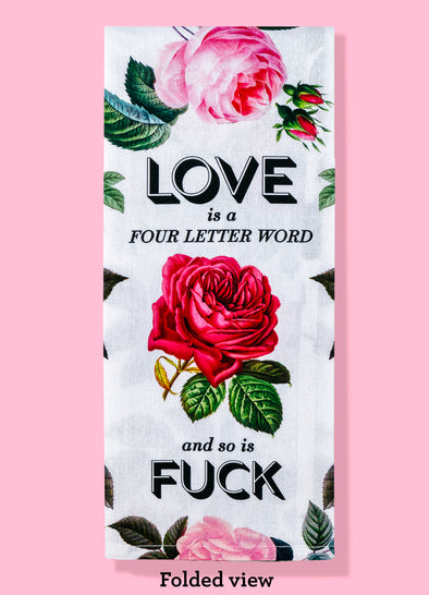 The "Love Is A Four Letter Word And So Is Fuck" dish towel by Bad Grandma Designs, shown folded. The text is black and the rest of the towel is covered in red and pink roses.