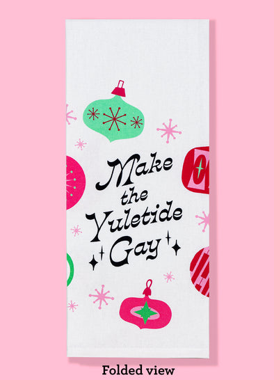 The "Make the Yuletide Gay" dishtowel, shown folded into thirds. It features the text as well as illustrations of Christmas ornaments. 