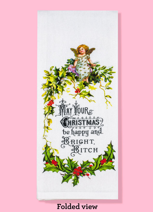 Folded dish towel view with "May your Christmas be happy and bright bitch" surrounded by mistletoe with a cherubic angel at the top  
