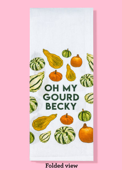 Folded view of the Oh My Gourd Becky dishtowel featuring illustrations of seasonal gourds and forest green text.