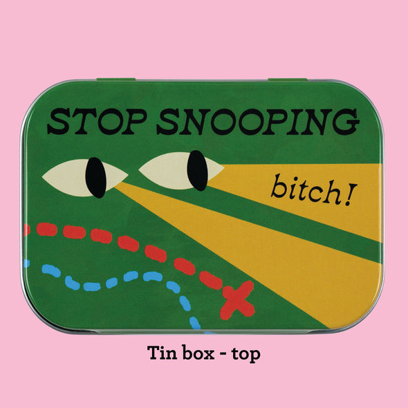 The top of the Stop Snooping Bitch tin, showing design elements on a green background with black text that reads "Stop Snooping Bitch!"
