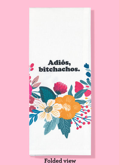 Folded dishtowel with the phrase Adios, Bitchachos and a floral illustration.