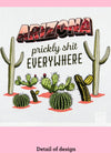 Close-up of a dishtowel with the phrase Arizona, Prickly Shit Everywheres an illustration of cacti including saguaro, barrel cactus, and prickly pear.