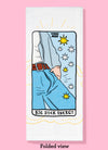 Folded dishtowel with phrase Big Dick Energy and an illustration of a tarot card showing the bulging crotch of a man's jeans.