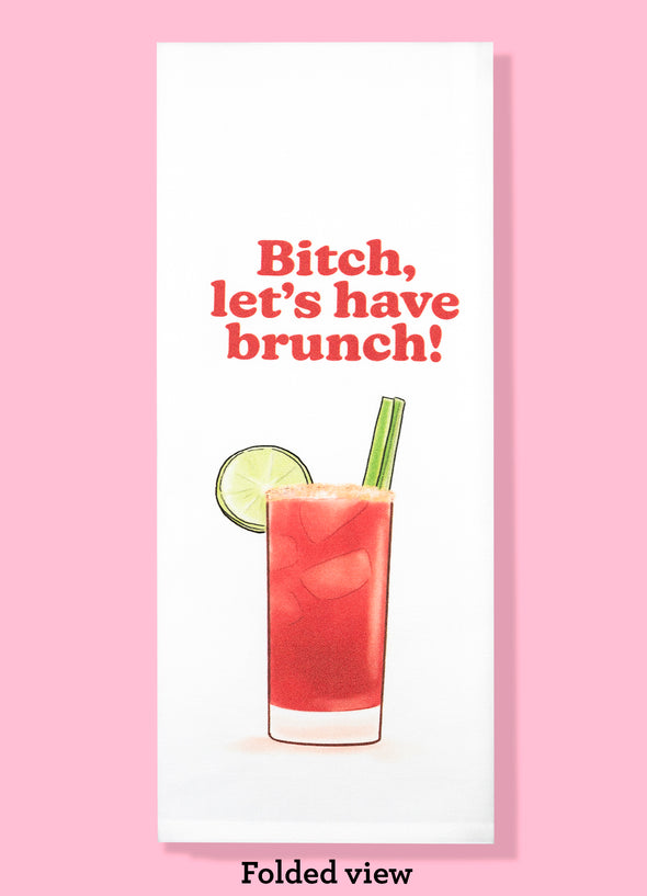 Folded dishtowel with the phrase Bitch, Let's Have Brunch and an illustration of a Bloody Mary cocktail.