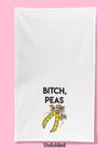 Unfolded dishtowel with the phrase Bitch, Peas and an illustration of peas in a pod.