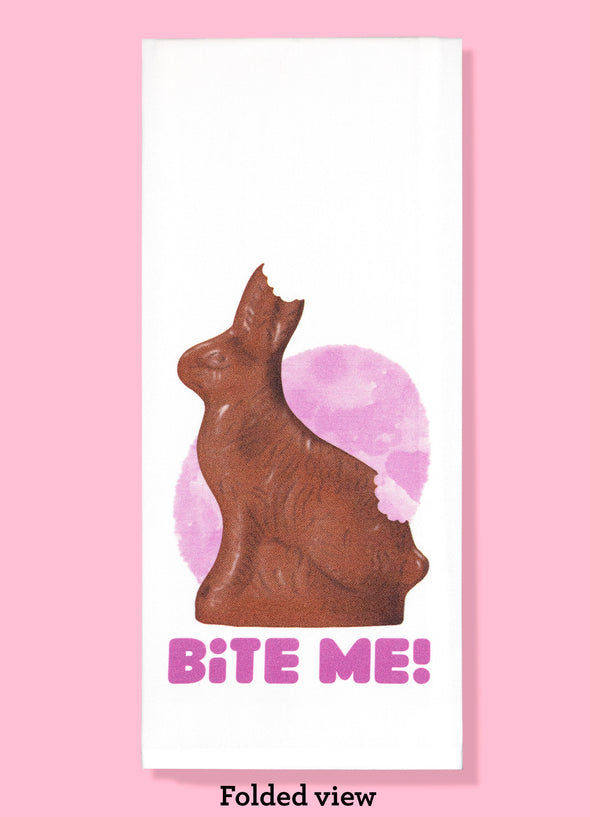 Folded dishtowel with the phrase Bite Me and an illustration of a chocolate bunny with a bite taken out of its ear and rump.