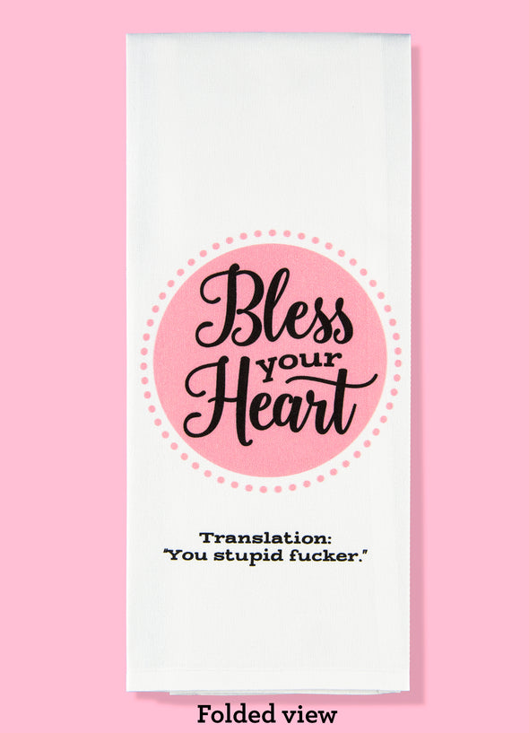Folded dishtowel with the phrase Bless Your Heart in large script text with smaller text with the punchline Translation You Stupid Fucker. 