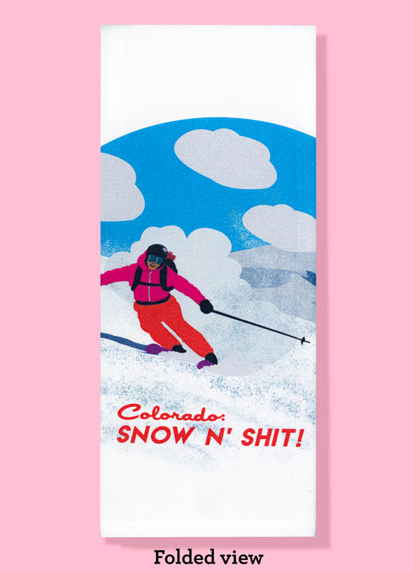 Folded dishtowel with an illustration of a person skiing and the phrase Colorado Snow N Shit.