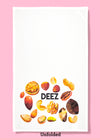 Unfolded dishtowel with illustration of shelled tree nuts and the phrase Deez.