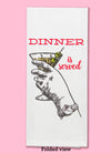 Folded dishtowel with an illustration of a hand holding a martini with olives and the phrase Dinner is Served.