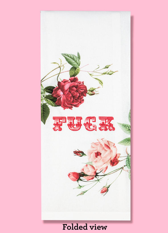 Folded dishtowel with the word Fuck along with vintage rose illustrations.