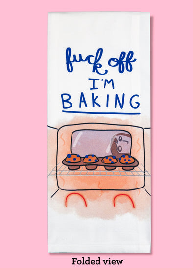 Folded dishtowel with an illustration of a person looking into an oven with the phrase Fuck Off I'm Baking.