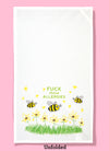 Unfolded dishtowel with an illustration of a bee, grass and flowers with the phrase Fuck These Allergies.