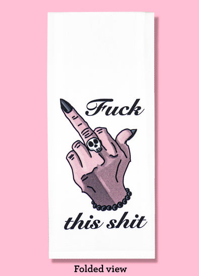 Folded dishtowel with an illustration of a hand with long black fingernails extending the middle finger and the phrase Fuck This Shit.