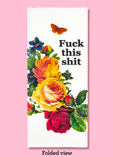 Folded dishtowel with an floral illustration and the phrase Fuck This Shit.