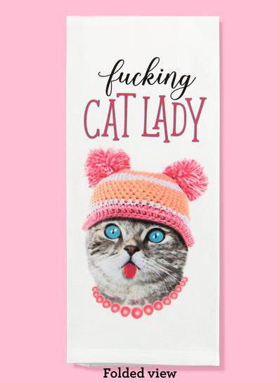 Folded dishtowel with an illustration of a funny cat wearing a hat an a necklace with the phrase Fucking Cat Lady.