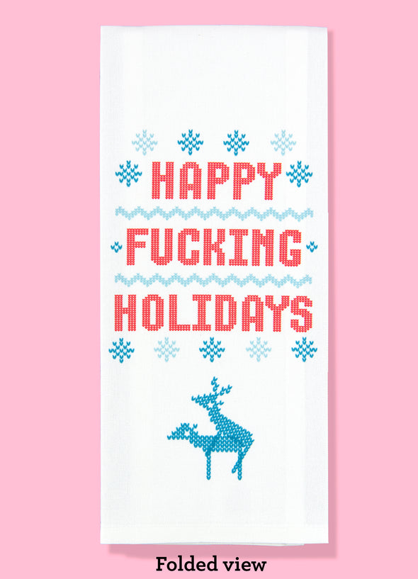 Folded dishtowel featuring a pattern that looks like a knit sweater with two reindeers having sex. The design includes the phrase Happy Fucking Holidays.