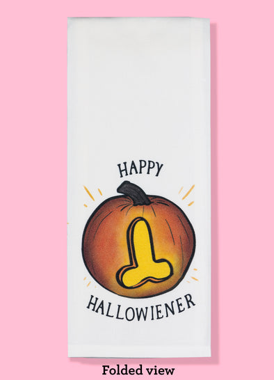 Folded dishtowel with an illustration of jack o lantern with an erect penis carved in the pumpkin instead of a face. The towel features the phrase Happy Hallo Wiener.
