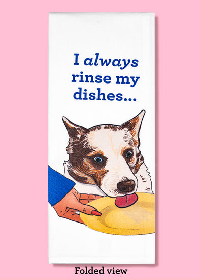 Folded dishtowel with an illustration of a dog licking a dinner plate with the phrase I Always Rinse My Dishes.