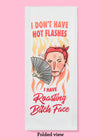 Folded dishtowel with the phrase I don't have hot flashes I have roasting bitch face. The illustration is of a cartoon woman's head looking annoyed and sweating, fanning herself with a fan.