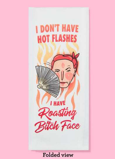 Folded dishtowel with the phrase I don't have hot flashes I have roasting bitch face. The illustration is of a cartoon woman's head looking annoyed and sweating, fanning herself with a fan.