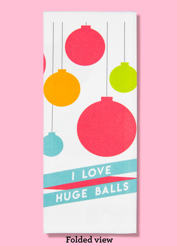 Folded dishtowel with a mid century modern illustration of Christmas ornaments and the phrase I Love Huge Balls.