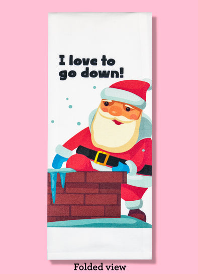 Folded dishtowel with an illustration of Santa going down a chimney with his tongue out and the phrase I Love to Go Down.