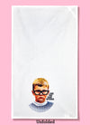 Unfolded dishtowel with a retro image of a boy in glasses with the phrase I See You Fake Bitches.