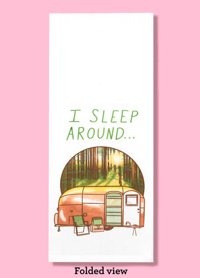 Folded dishtowel with an illustration of an R V trailer in a forest setting with the phrase I Sleep Around.