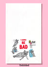Unfolded dishtowel with illustrations of cats doing bad things and the phrase I Wanna Be Bad.