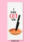 Folded dishtowel with an illustration of a massive black knife sticking into a pumpkin pie and the phrase I Will Cut You.