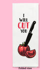 Folded dishtowel with an illustration of a massive black knife sticking into a ripe tomato and the phrase I Will Cut You.