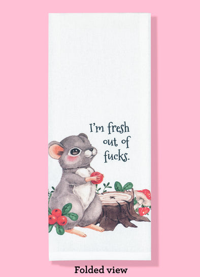 Folded dishtowel with an illustration of a cute woodland animal and the phrase I'm Fresh Out of Fucks.