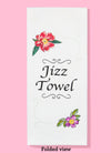 Folded dishtowel with floral illustrations and the phrase Jizz Towel.
