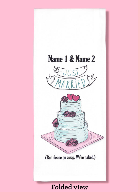 Folded dishtowel demonstrating how this product can be personalized. It features text that says Name 1 & Name 2 and an illustration of a wedding cake with the phrase Just Married But Please Go Away We're Naked.