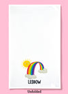 Unfolded dishtowel of a smiling sun peeking out behind a rainbow with the phrase Lesbow.