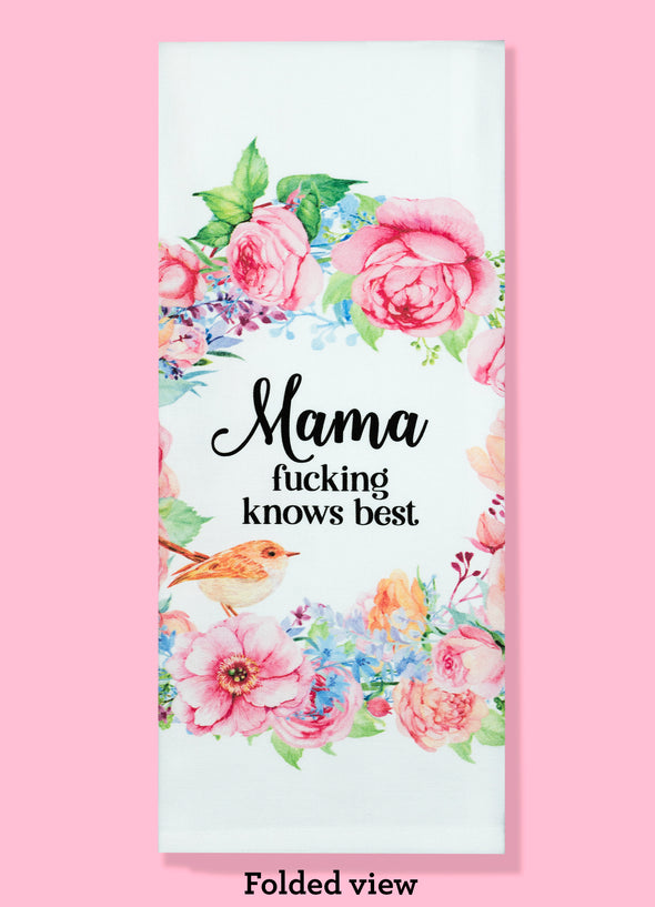Folded dishtowel with an illustration of a floral wreath and the text Mama Fucking Knows Best.