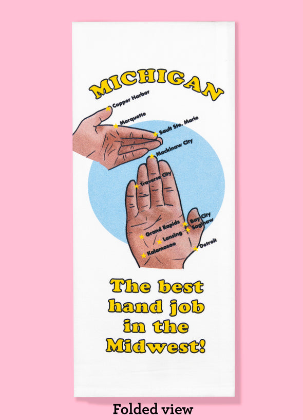 Folded dishtowel with an illustration of the Michigan map as a pair of hands and the phrase Michigan, the Best Hand Job in the Midwest. Cities featured on the map include Marquette, Salut Saint Marie, Mackinaw City, Detroit, Lansing, and Kalamazoo.