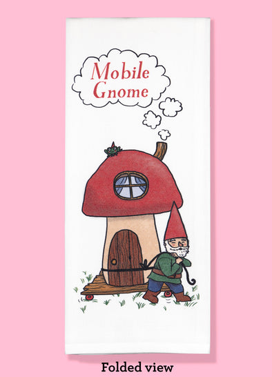 Folded dishtowel with the phrase mobile gnome. The illustration if of a cartoon gnome pulling a cart with a mushroom house on it
