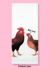 Folded dishtowel with an illustration of a rooster and hen facing one another. The hen has a speech line, saying nice cock.