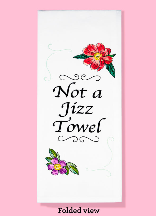 Folded dishtowel with floral illustrations and the phrase not a jizz towel